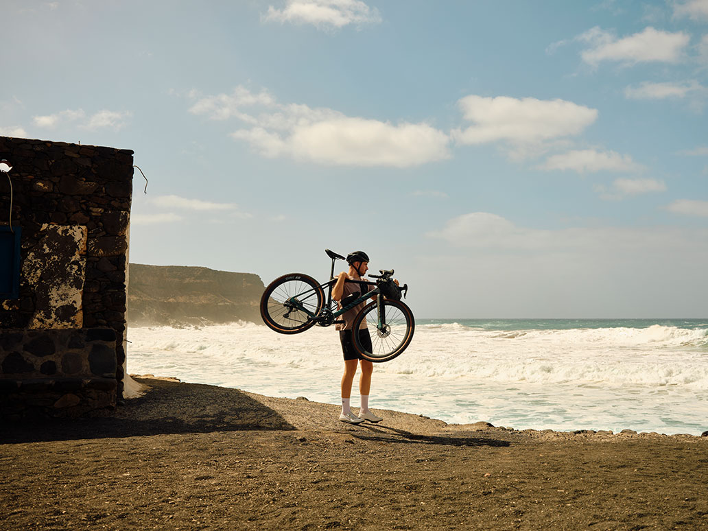 Radfahrer trägt Gravel Fahrrad in Cargo Bib Shorts und Aexplore Gravel Shirt